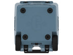 Underside of the slate-blue wheeled cooler showing four rubber feet, two wheels and a molded C logo
