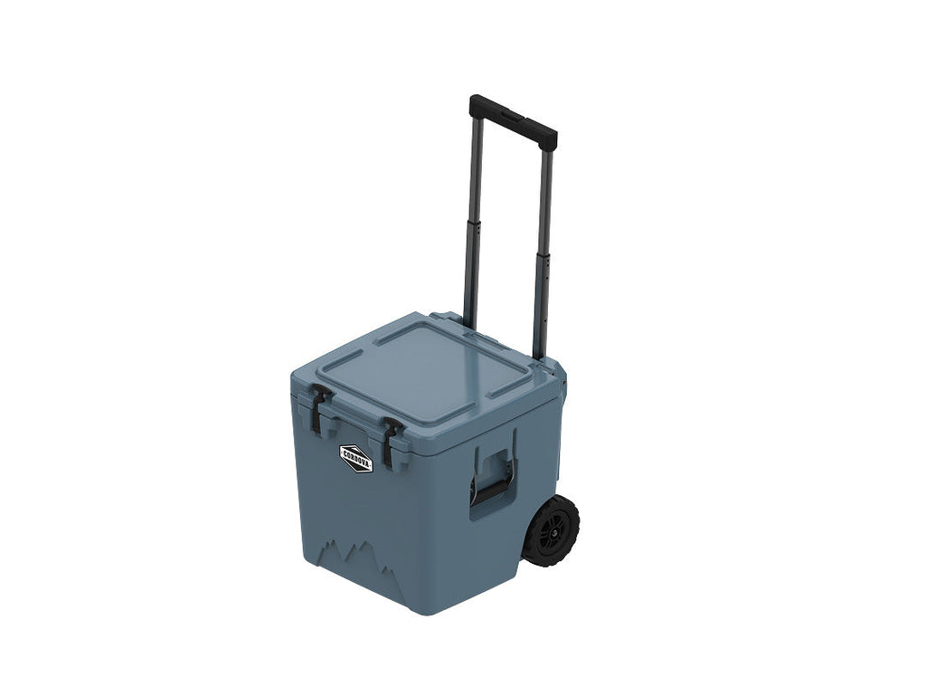 Slate-blue wheeled cooler from above at an angle, lid closed, handle raised