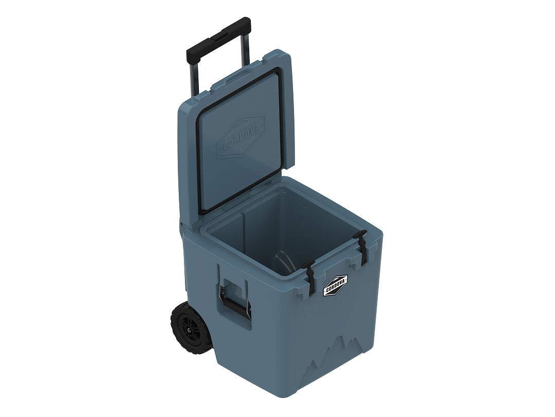 Slate-blue wheeled cooler from above at an angle, lid open, handle raised
