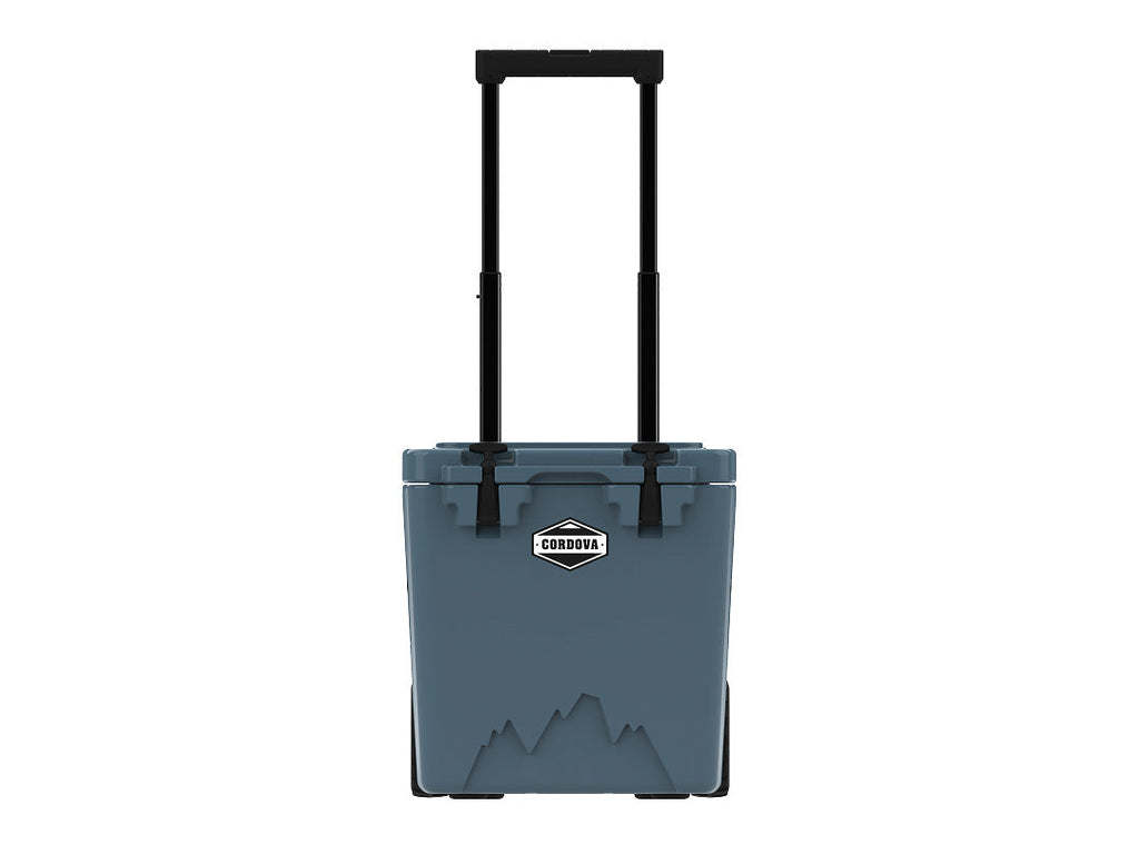 Slate-blue wheeled hard cooler from the front with its telescoping handle fully raised