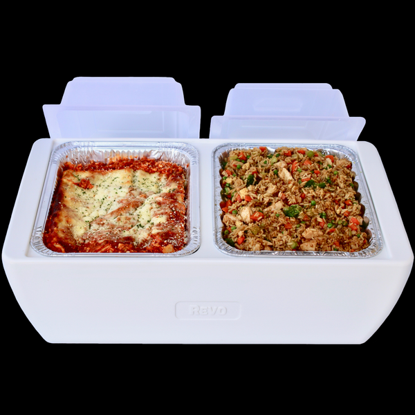 White two-compartment cooler holding a pan of baked lasagna and a pan of fried rice, clear lids open behind