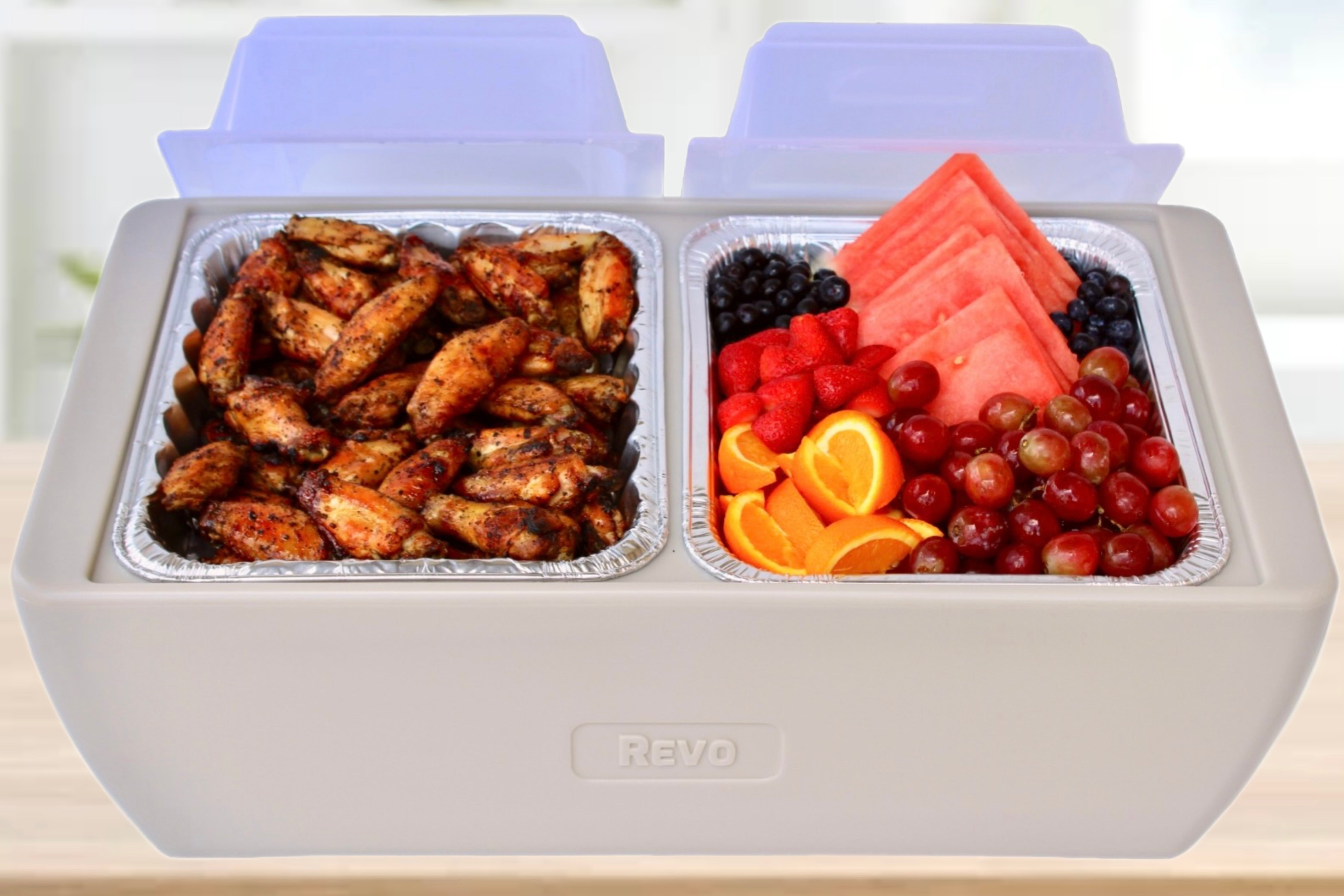 Taupe two-compartment cooler with a clear dome lid, white condiment trays, an aluminum scoop and two microwave heat packs