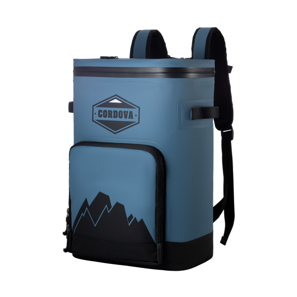 Slate-blue backpack cooler from the front, with a zip front pocket, mountain graphic and black padded straps