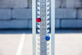 Load image into Gallery viewer, Close-up of the numbered score track with a red knob at 14 and a blue knob at 10, parking lot in the background
