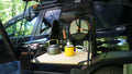 Load image into Gallery viewer, Kitchen bag hanging from an SUV's open rear door with the bamboo board out, a kettle and yellow mug on top
