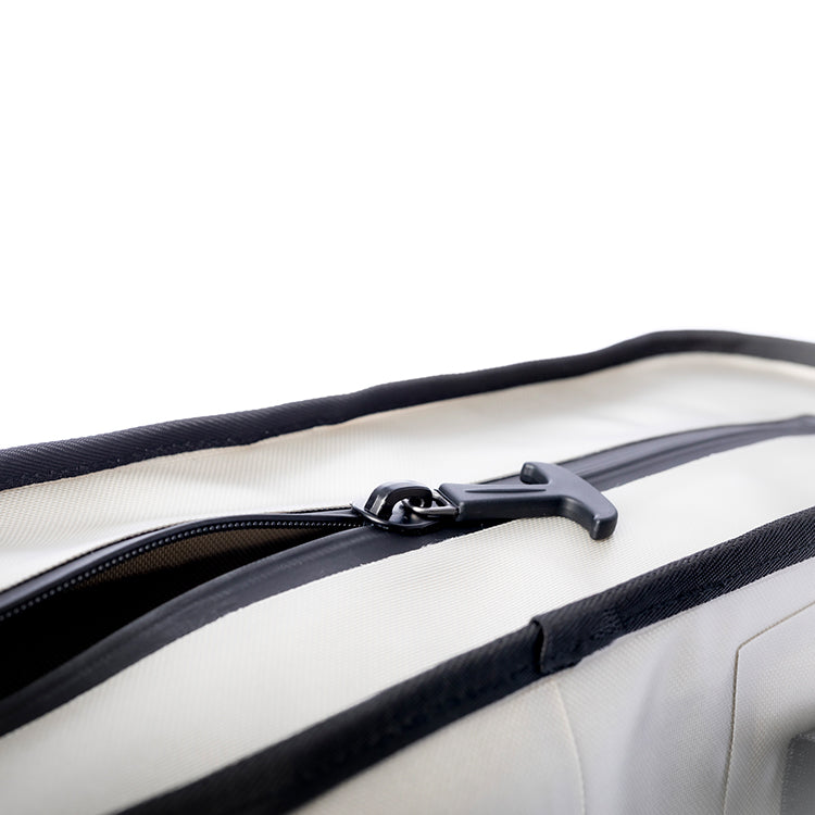 Close-up of the Sidekick's wide zip top partly open with a large zipper pull