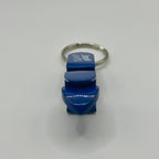 End-on view of the blue opener and shotgun tool, showing the pointed tip used to punch a hole in a can