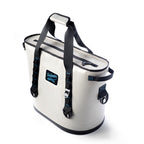 Sidekick tote cooler from the front right, showing the zip top, side handle and buckled carry straps