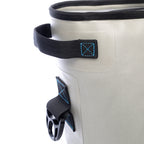 Close-up of a side grab handle and a strap loop on the Sidekick's light gray shell