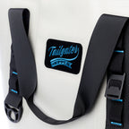 Close-up of the Tailgater Supply patch, buckle and blue-stitched carry strap on the Sidekick