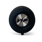 End of the black DryTunes speaker showing the round metal Yak Power cap