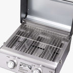 Looking down into the open grill at stainless grates and two burner tubes
