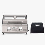 Stainless tabletop grill with a window lid next to a black Monument grill cover