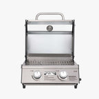 Straight-on view of the open grill showing the lid's window, thermometer and stainless grates