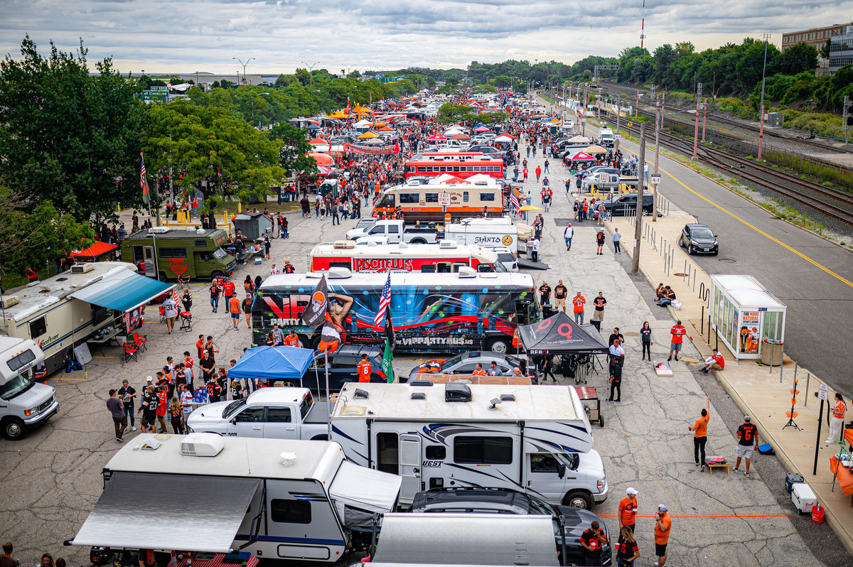 Rows of RVs and tents in a game-day parking lot